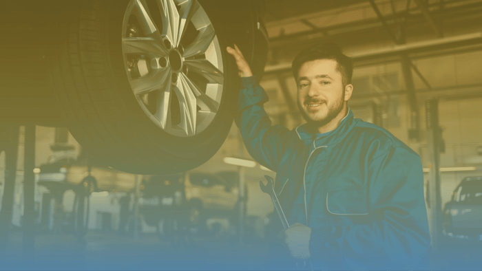 technician standing next to tire 