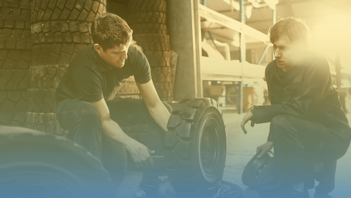 two technicians working on tires